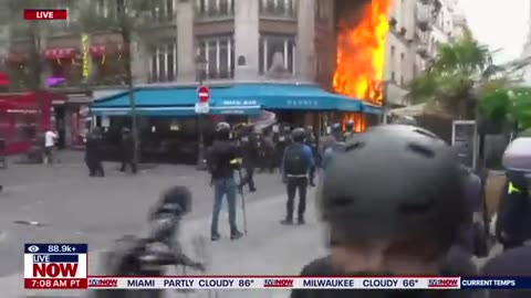 in flames: Protesters set fire to Paris buildings,