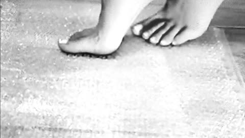 Pretty feet popping bubbles