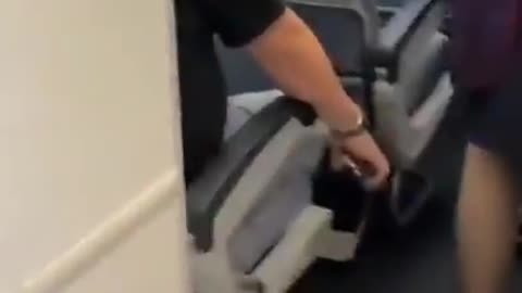 Man arrested for filming up a flight attendant's skirt. Caught in the act.