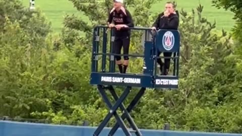 Luis Enrique watching his team train on a lift