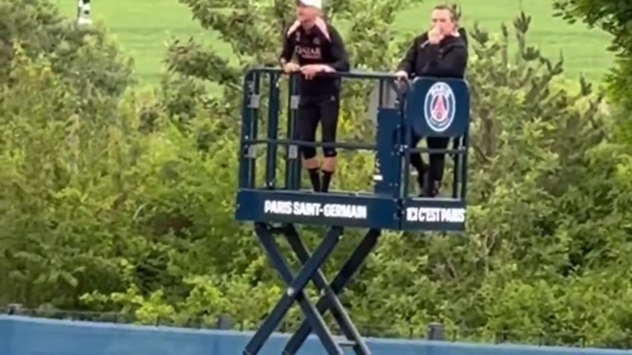 Luis Enrique watching his team train on a lift