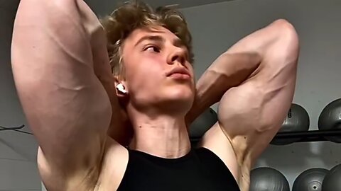 Young aesthetic bodybuilder flexing muscles