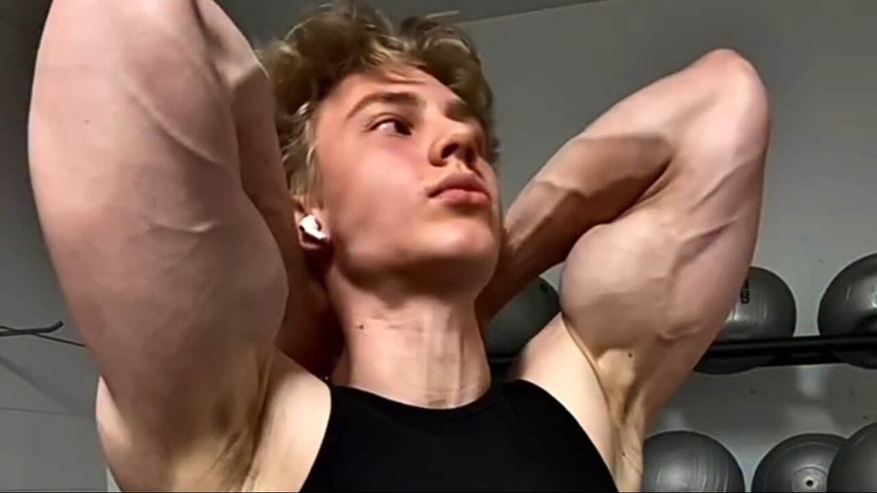 Young aesthetic bodybuilder flexing muscles