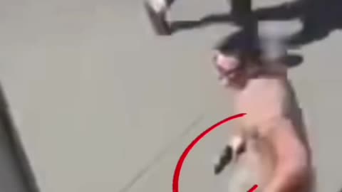 Is this man running with a hand gun??