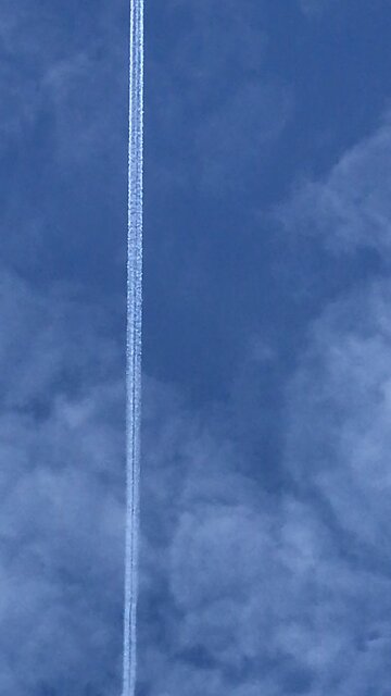 Plane with white trail Wales UK 21/11/2025