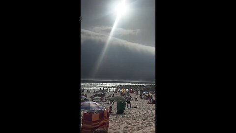 Beachgoers in Portugal witnessed a rare phenomenon as a "tsunami of dark clouds" loomed overhead