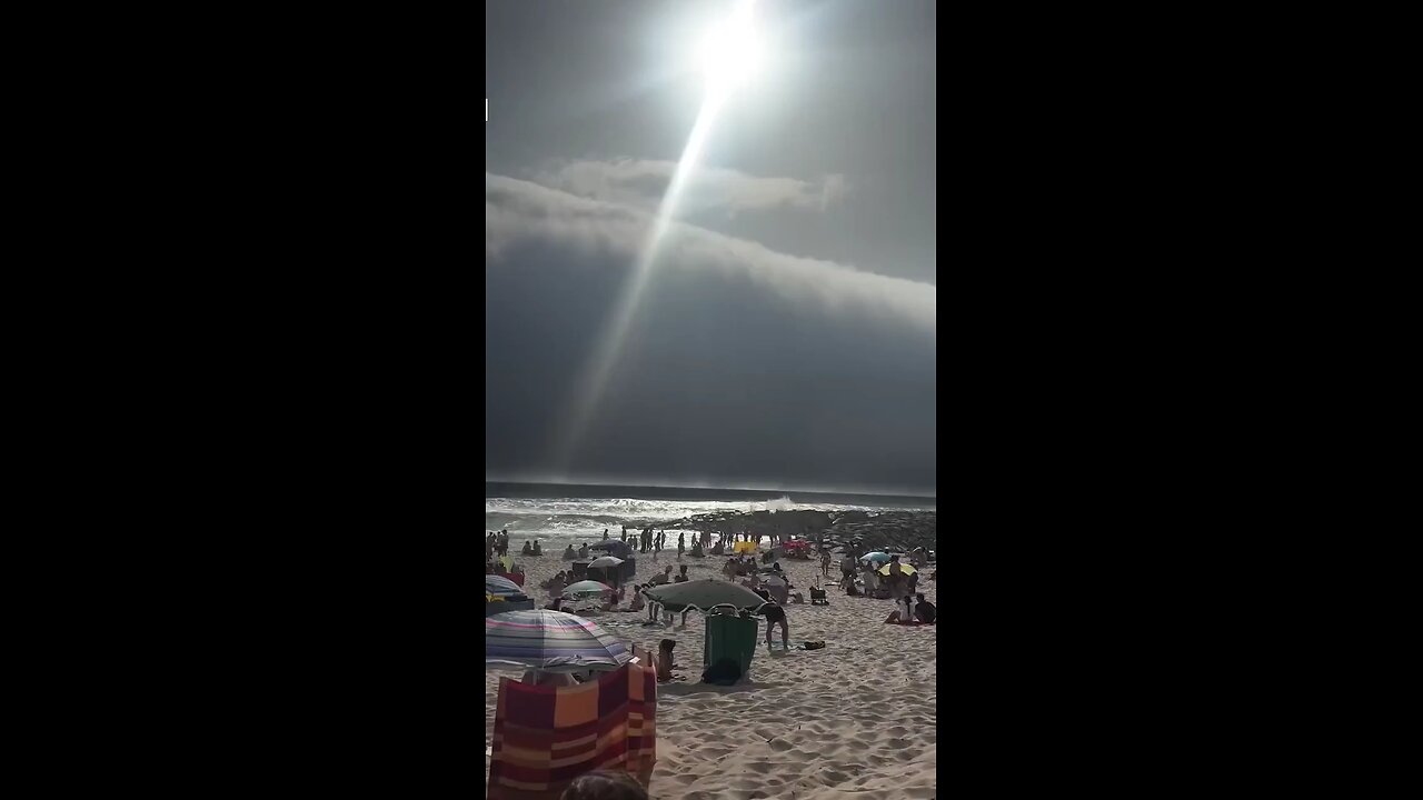 Beachgoers in Portugal witnessed a rare phenomenon as a tsunami of dark clouds loomed overhead