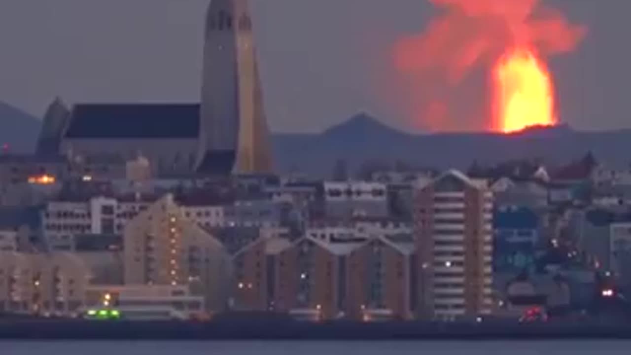 Reykjavik, Iceland with a volcano erupting behind it