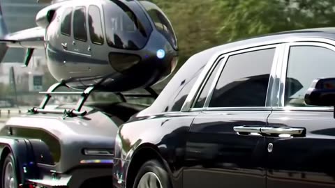 Rolls-Royce Hauling a Helicopter Through the City Streets