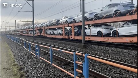 METEREN, NL - Jan 31, 2025: A Train with new Tesla cars driving past while