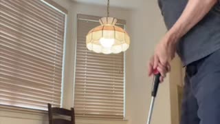 He swings golf club inside