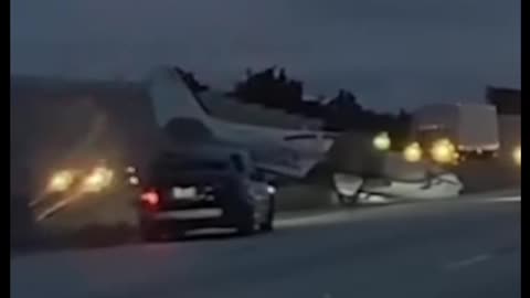 Plane Lands on Car Traveling Down Interstate