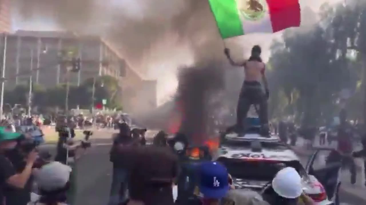 Waving the flag of the country they try to escape from