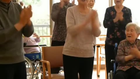 elderly people in a nursing home are singing and having fun