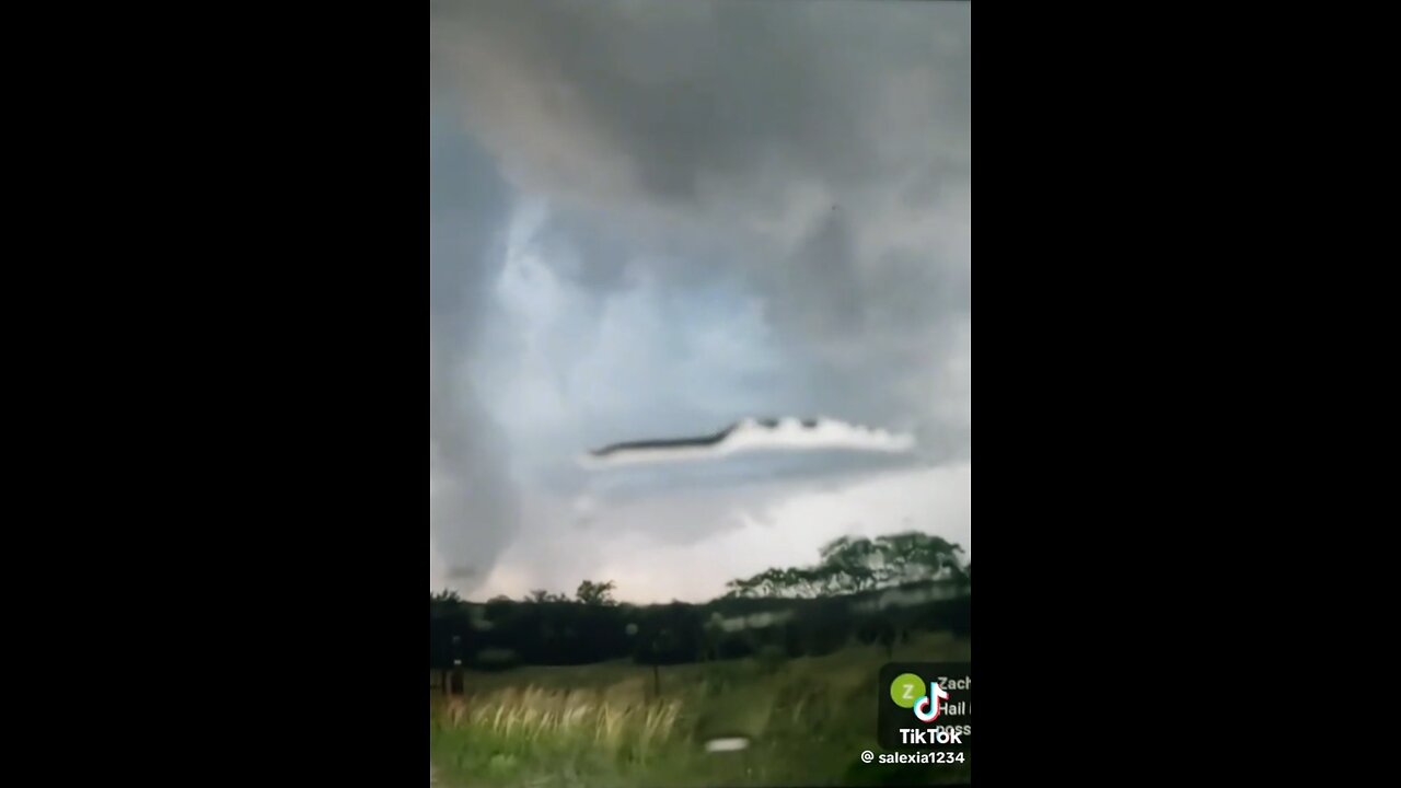 Cloaked UFO appears next to a tornado while the weatherman tries to obscure the area.