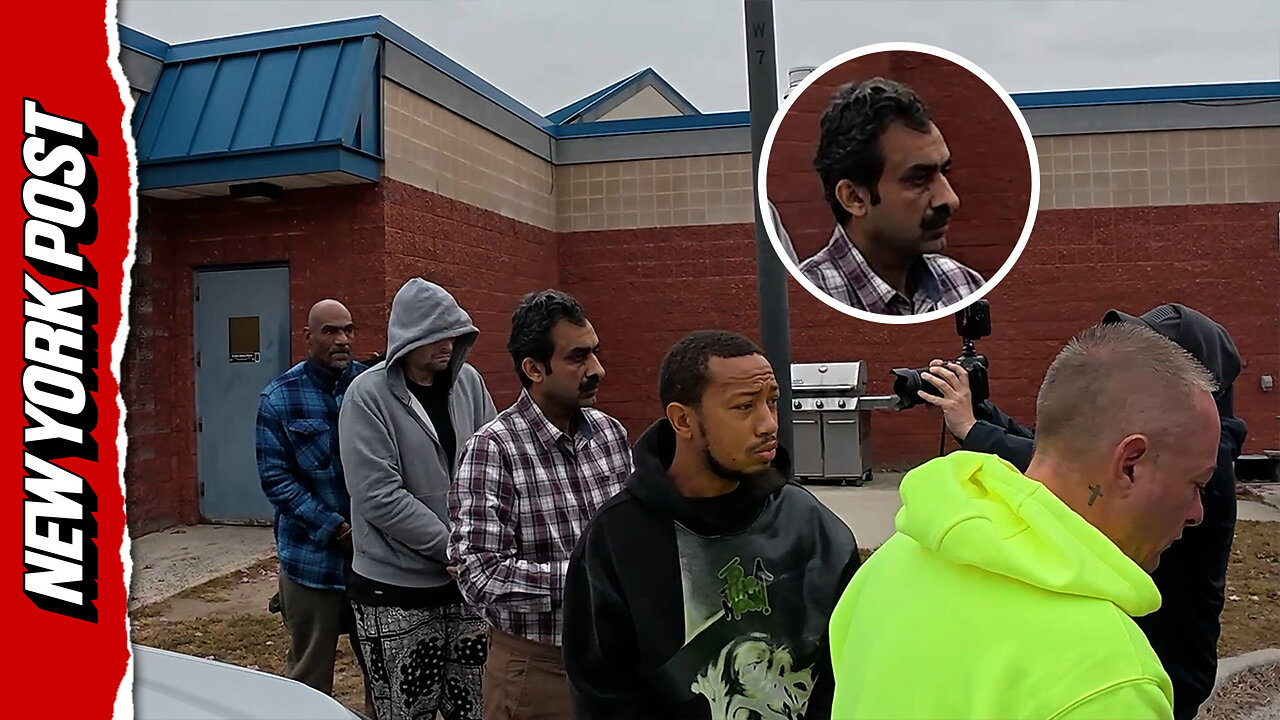 Aqeel Ahmad, fourth from the back with mustache, is walked out of the Suffolk County 6th precinct on Oct. 29.