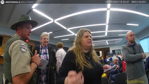 An Armed Ohio police officer physically prevented a reporter from interviewing a public official