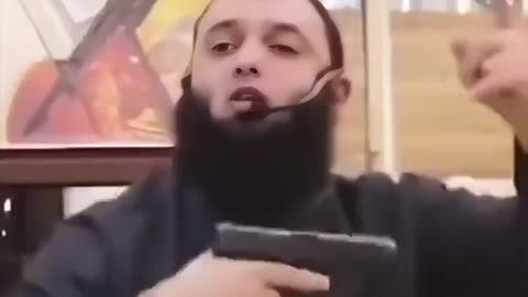 Muslim leader waives his gun inside a mosque and proudly proclaims