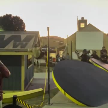 He hits his head on the edge of the roof.