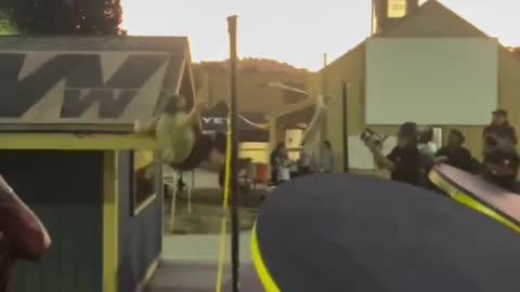 He hits his head on the edge of the roof.