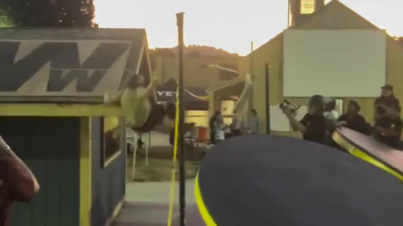 He hits his head on the edge of the roof.