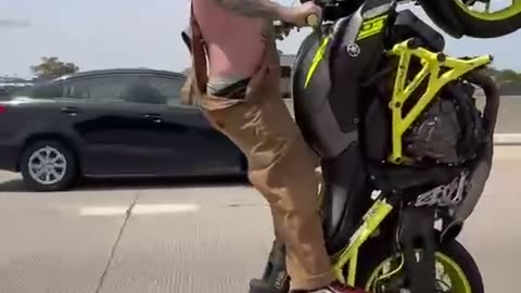 Stunt Rider Crashes Bike on Highway