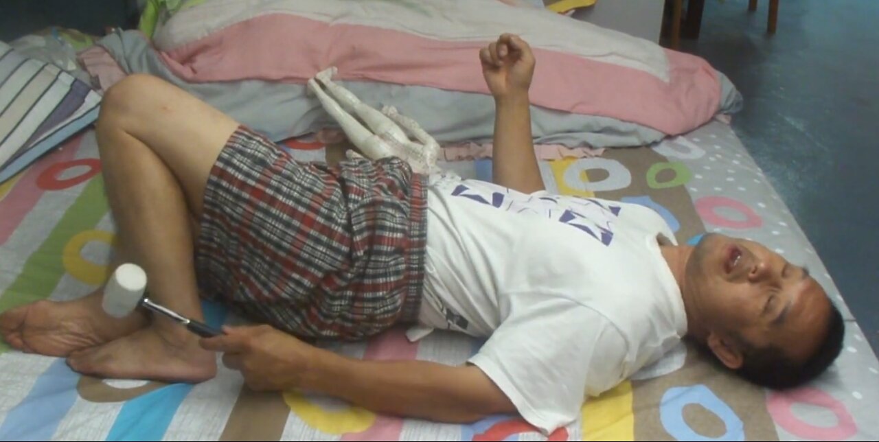Luodong Massages Himself At Home On The Bed