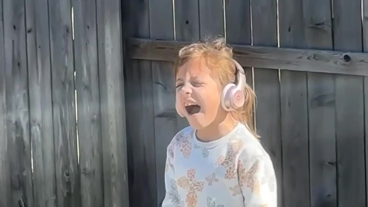 Girl Belts Out Wicked Song in Backyard