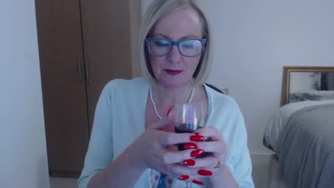 Anna at home with a glass of wine