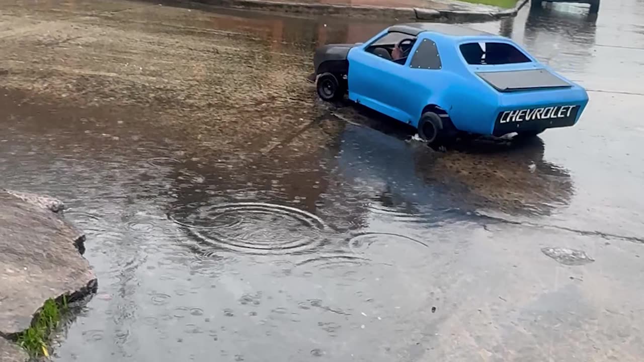 Miniature Car Goes For Rainy Cruise