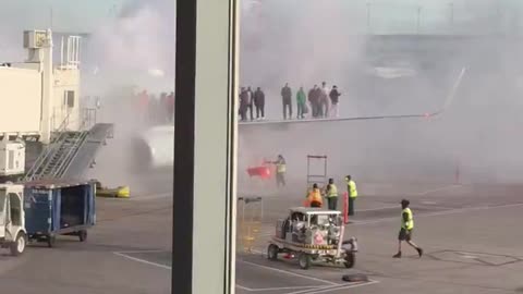 American Airlines plane catches on fire at Denver airport.