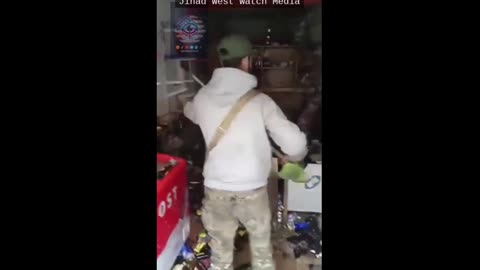 Syrian jihadists smash liquor bottles in Aleppo's conquered Kurdish neighborhood,