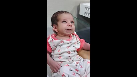 newborn baby girl is in good mood