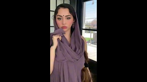 The girl is looking outside