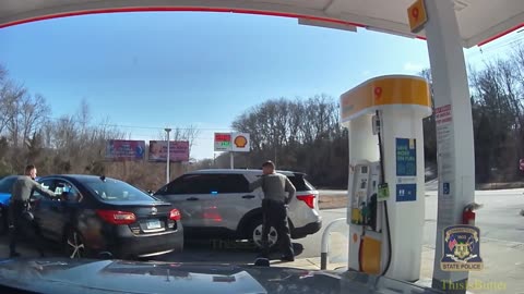 Woman slams into cop cars, gas pump and guardrail at a gas station