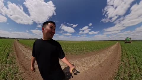 Man Nearly Hit by Giant Spraying Tractor Arm While Walking Through Field