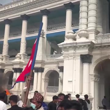 Nepalese protesters rejoicing in front of the burning Parliament. @PressTV