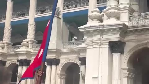 Nepalese protesters rejoicing in front of the burning Parliament. @PressTV