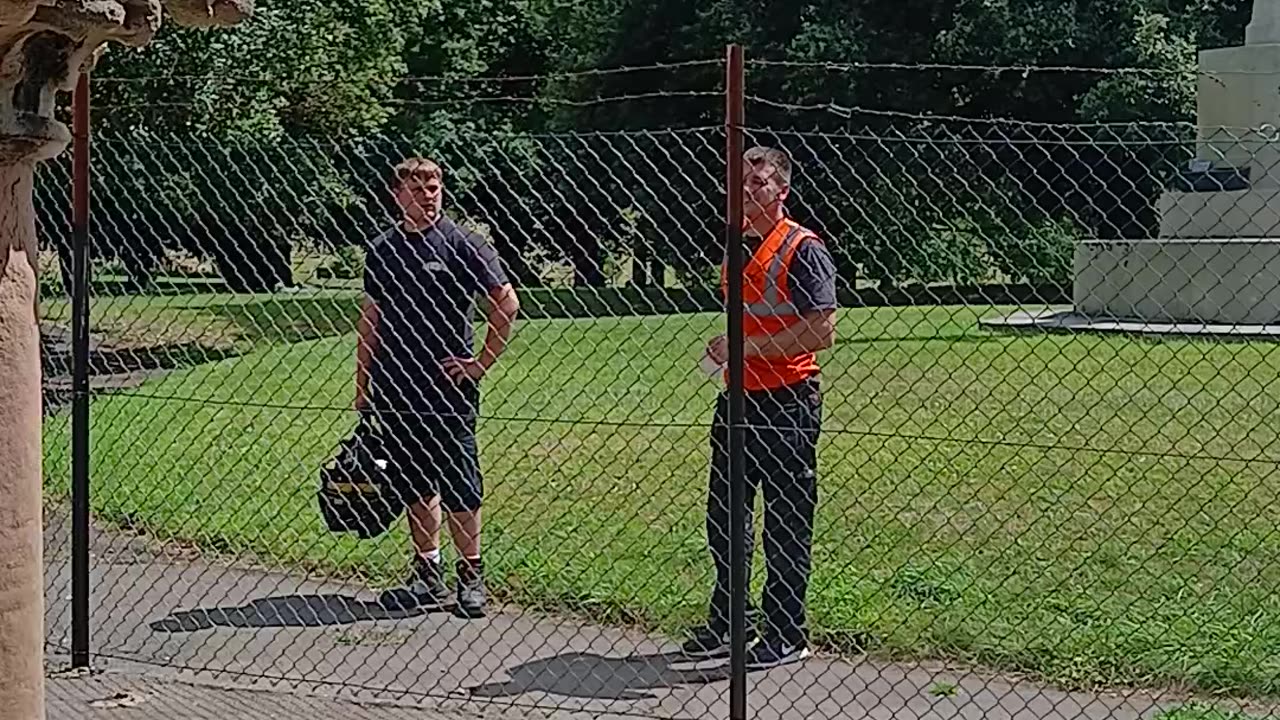 People @ the fence not clinging 2 barbed wire 4 a change