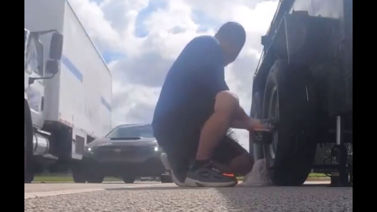Man records himself changing tire on side of road, causes accident