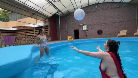 Lovely Girls Play VolleyBall in the Pool