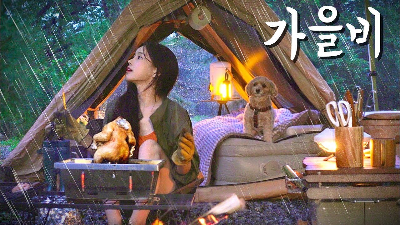 A cold glass of beer with a can of chicken in the forest where autumn rain falls