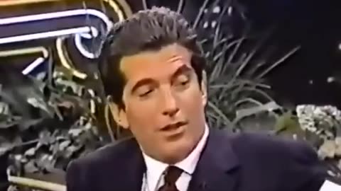 JFK Jr. reads a poem written by Monica Lewinsky where she creatively describes herself as a pizza
