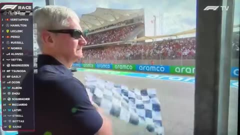 F1 USA GP 2022 Tim Cook waving chequered flag like a dead fish