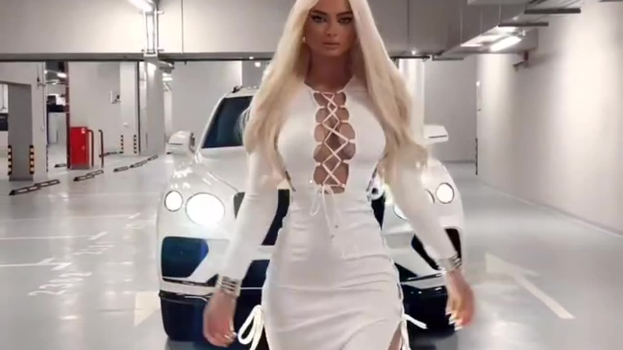 Auto Lady strutting front of a Bentley Bentayga