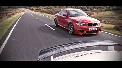 Porsche Cayman R and BMW 1-series M Coupe drifting sideways
