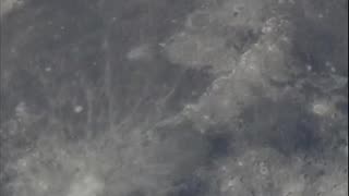 What do you notice about the far side of the moon when zoomed in?
