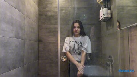 Wetlook girl in Sweater and Jeans gets wet in Shower