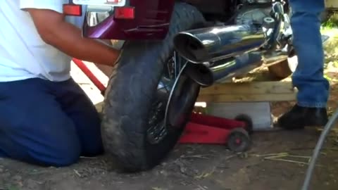 LOL of motorcycle repair lol with random kid jumping in front of camera