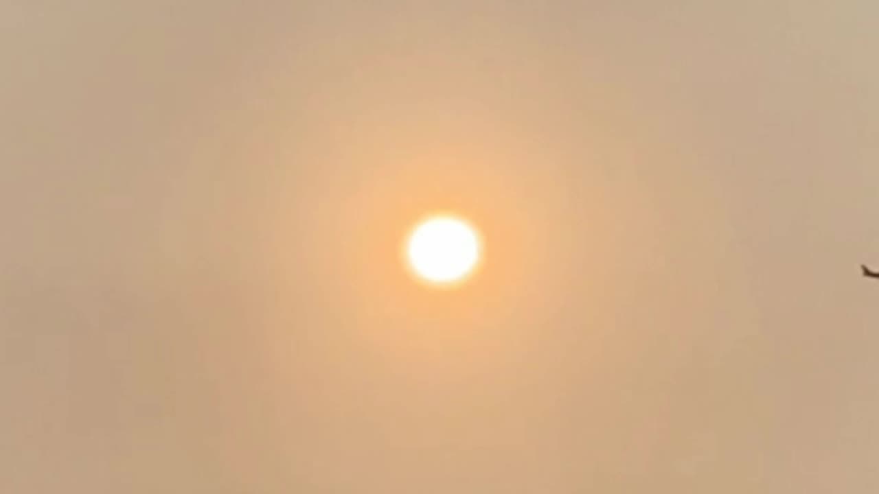 Plane flys behind the SUN